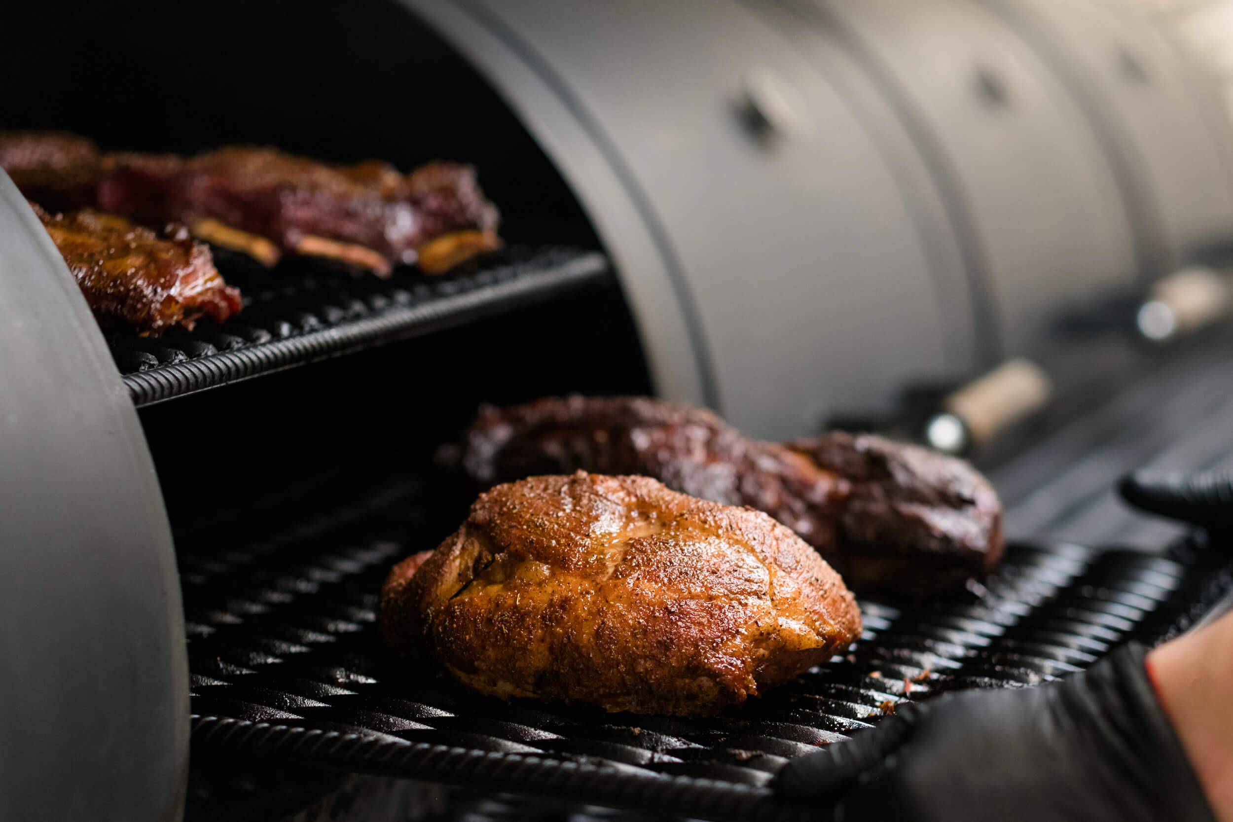 Close-up of meat cooking on a grill with a focus on texture and color.